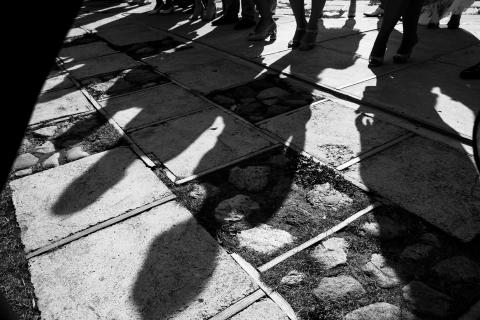 Shadows of people on the pavement