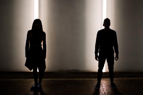 Silhouette of young couple dancing in street