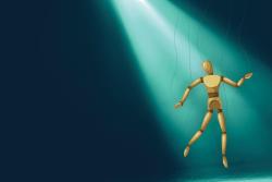 Wooden puppet hanging on strings