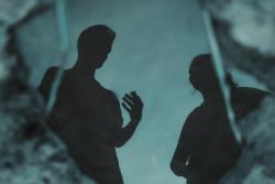 Two people talking in dark