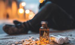 Person sitting next to drugs