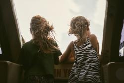 Two children looking out window