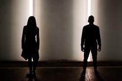 Silhouette of young couple dancing in street