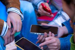 Group of people holding mobile phones