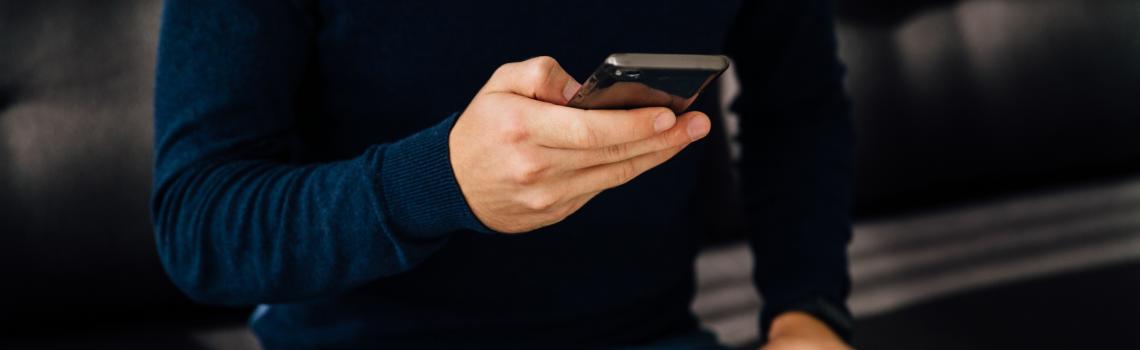 Male hand using mobile phone