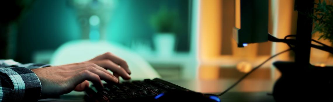 Person typing at computer's keyboard