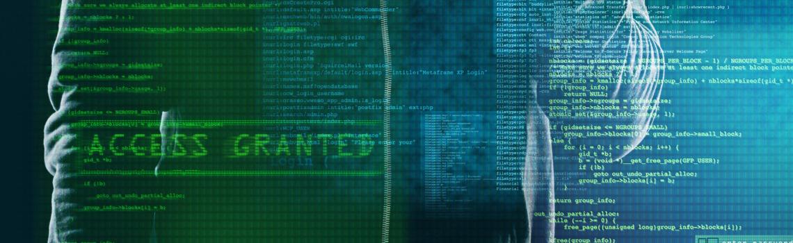 Computer screen with code and person holding phone behind code